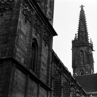 Gothic cathedral spire and detailed stone facade.
