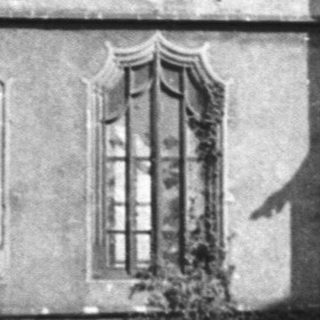 Historic Gothic-style building facade with arched windows.