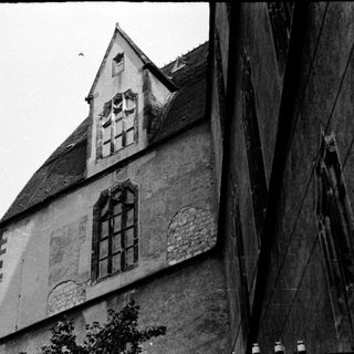 Historic stone building with steep gable roof.
