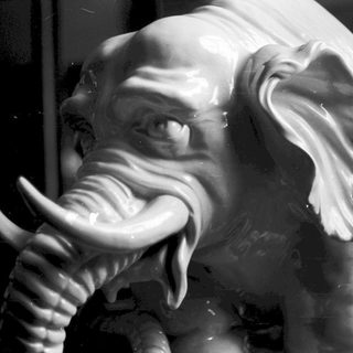 Statue of elephant giving thumbs-up gesture.