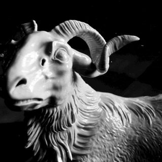 Mythical ram or goat head sculpture.