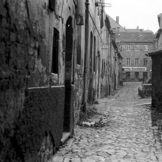 Narrow cobblestone street in old European town.