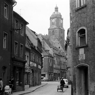 Historic European town street with clock tower.