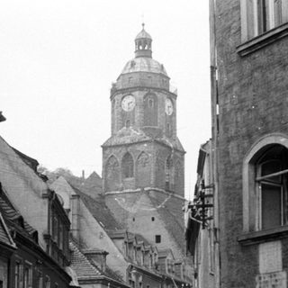 Historic European town street with clock tower.
