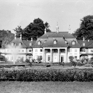 Elegant classical-style mansion with symmetrical architecture.