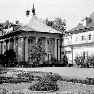 Elegant historic mansion with classical architecture and landscaped gardens.