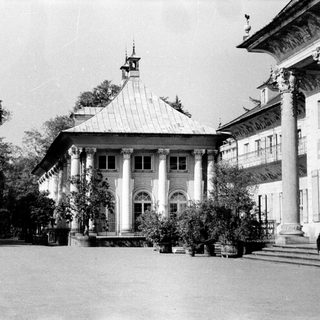 Historic colonial-style building with arched colonnade.
