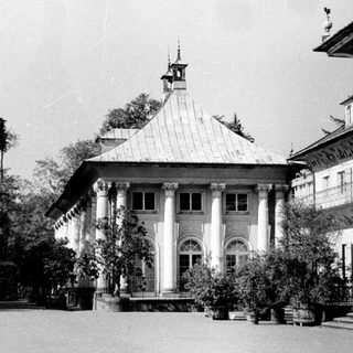 Historic colonial-style building with arched colonnade.