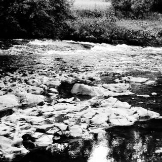 Frozen river with broken ice chunks.