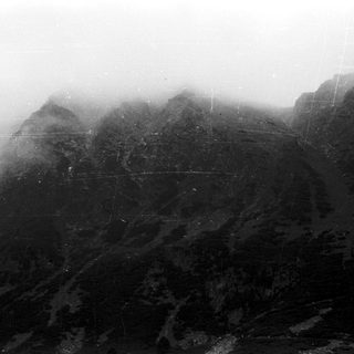 Misty mountain landscape with ancient terraced ruins.