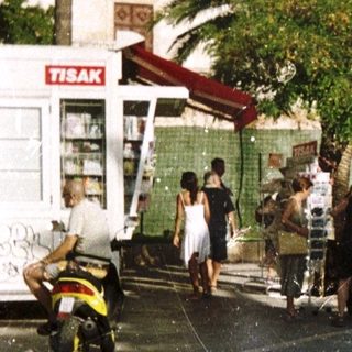 Woman standing on Mediterranean coastal town street.