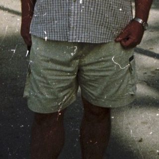 Man standing outdoors during festive water celebration.