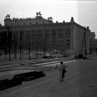 Vintage urban street scene with grand building.