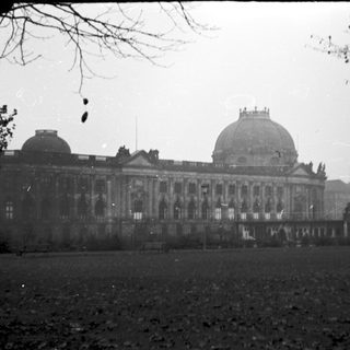 Grand, damaged historic building with dome.
