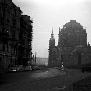 Damaged cathedral in urban setting, post-war era.