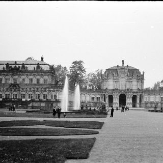 Baroque palace gardens with fountains and classical architecture.