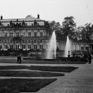 Baroque palace with grand fountain courtyard.