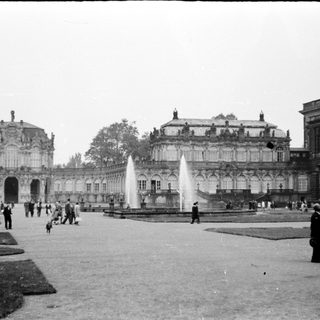 Historic palace courtyard with classical architecture and fountains.