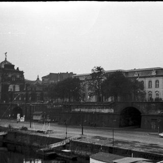 Historic urban scene with tunnel and grand architecture.