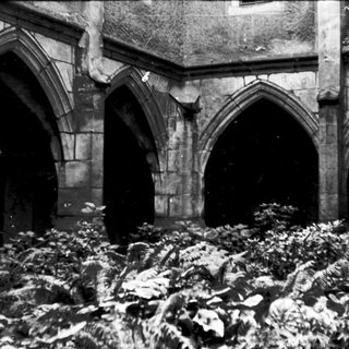 Gothic arches with snow-covered ground inside ruins.