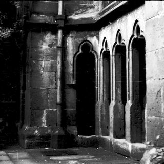 Gothic stone arches in ancient stone wall.