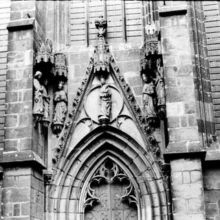 Gothic cathedral facade with sculpted religious figures.