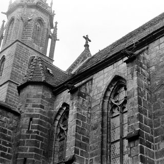 Gothic stone church facade with pointed arches.
