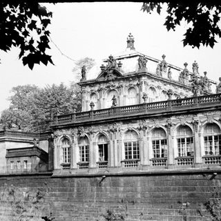 Baroque palace with ornate facade and statues.
