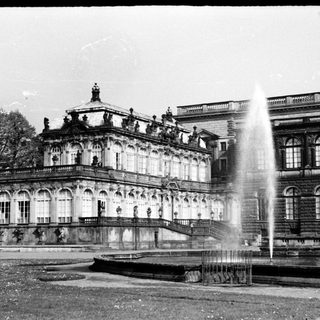 Grand historic palace with classical architecture and fountain.