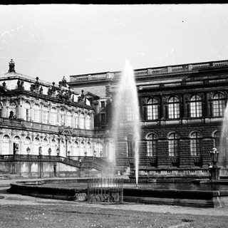 Grand historic palace with classical architecture and fountain.