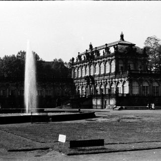 Grand historic building with fountain in courtyard.