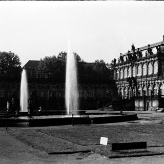 Grand historic building with fountain in courtyard.