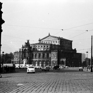 Historic grand building with vintage street scene.