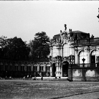 Baroque palace with ornate façade and gardens.