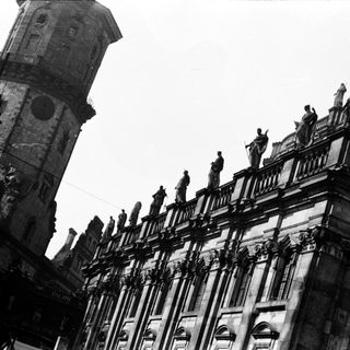 Historic European architecture with ornate towers and statues.