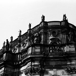Baroque-style building with ornate sculptures and columns.