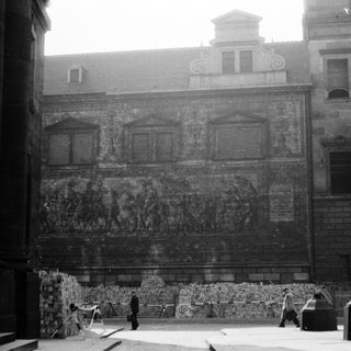Historic building facade with detailed relief sculptures.