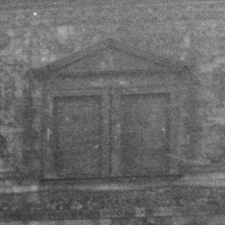 Historic building facade with detailed relief sculptures.