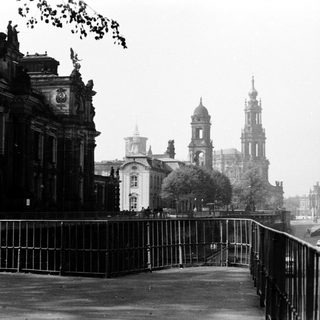 Historic cityscape with grand cathedral and classical buildings.