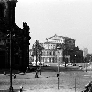 Historic city square with grand cathedral and opera house.