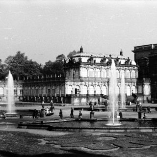 Historic palace courtyard with grand fountains and classical architecture.