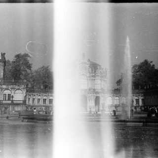 Historic palace with grand fountain and classical architecture.