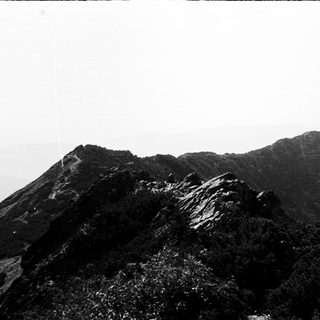 Misty volcanic mountain peak with rugged terrain.