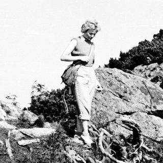 Person hiking on rocky mountain trail.