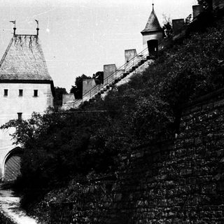 Medieval castle gatehouse with steep stone ramparts.