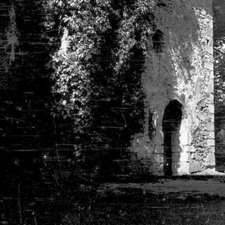 Ancient stone archway in shadowed ruins.