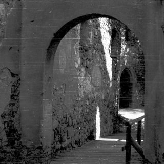 Underground chamber with arched stone walls.