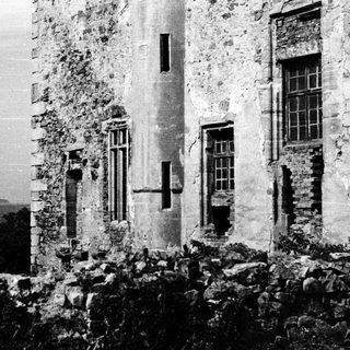 Abandoned stone building with weathered walls.