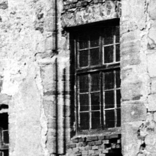 Abandoned stone building with weathered walls.