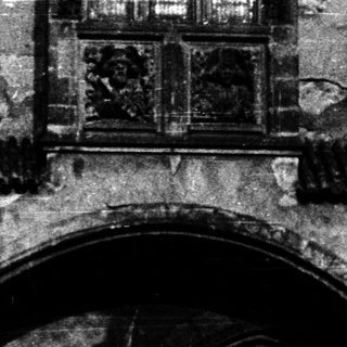 Gothic-style arched entrance with weathered stone facade.